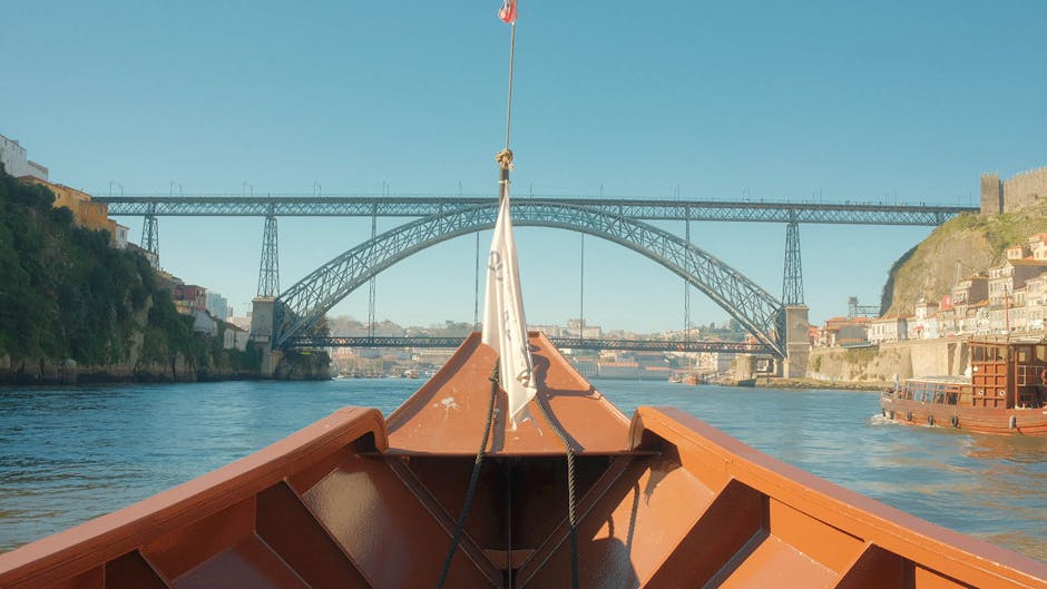 Stunning view from a boat of the Dom Luís I Bridge spanning the Douro River in Porto, Portugal.